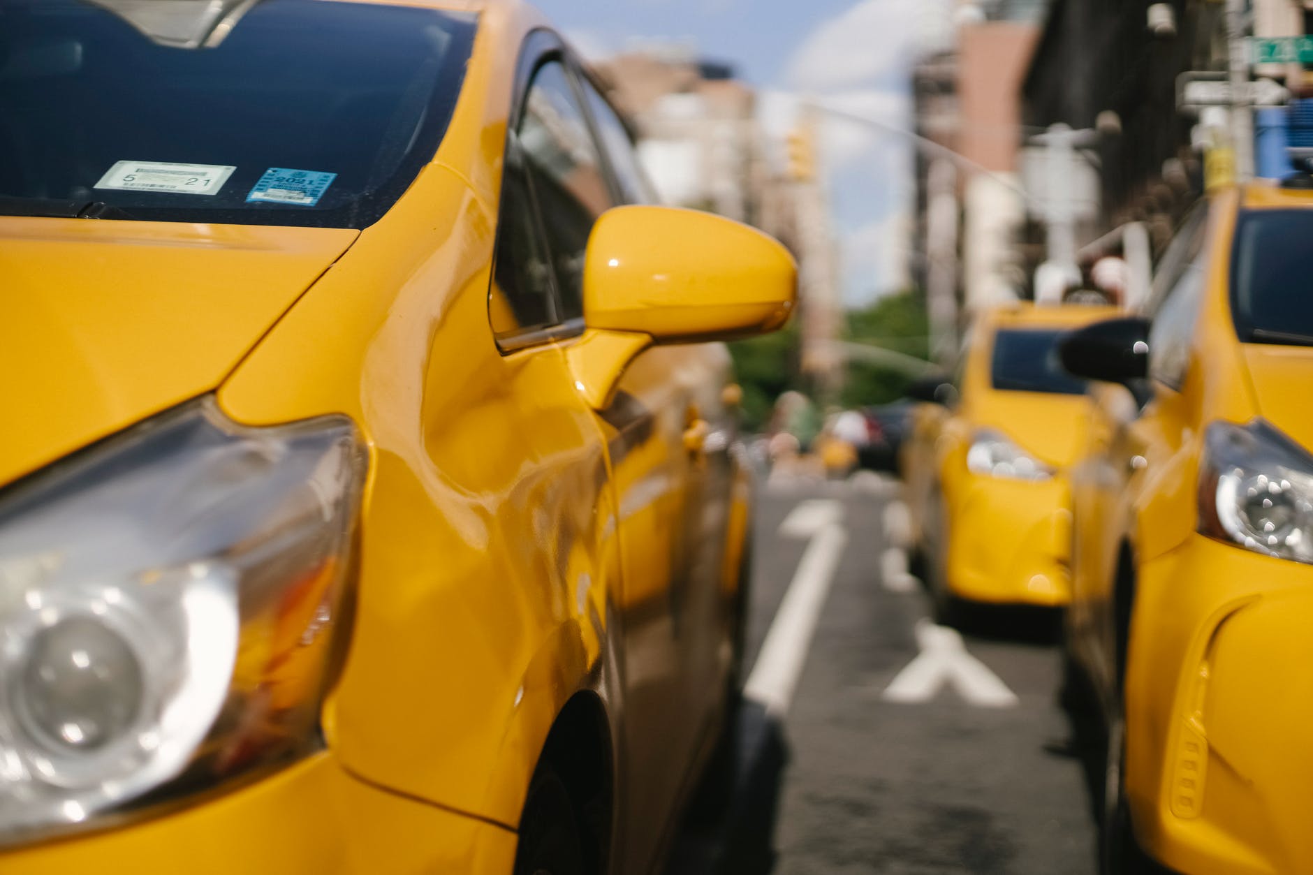 colorful modern taxi cars on city road